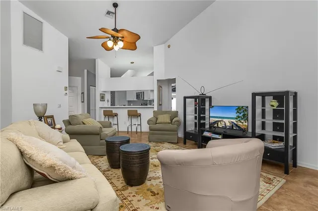 a living room with fireplace furniture and a chandelier