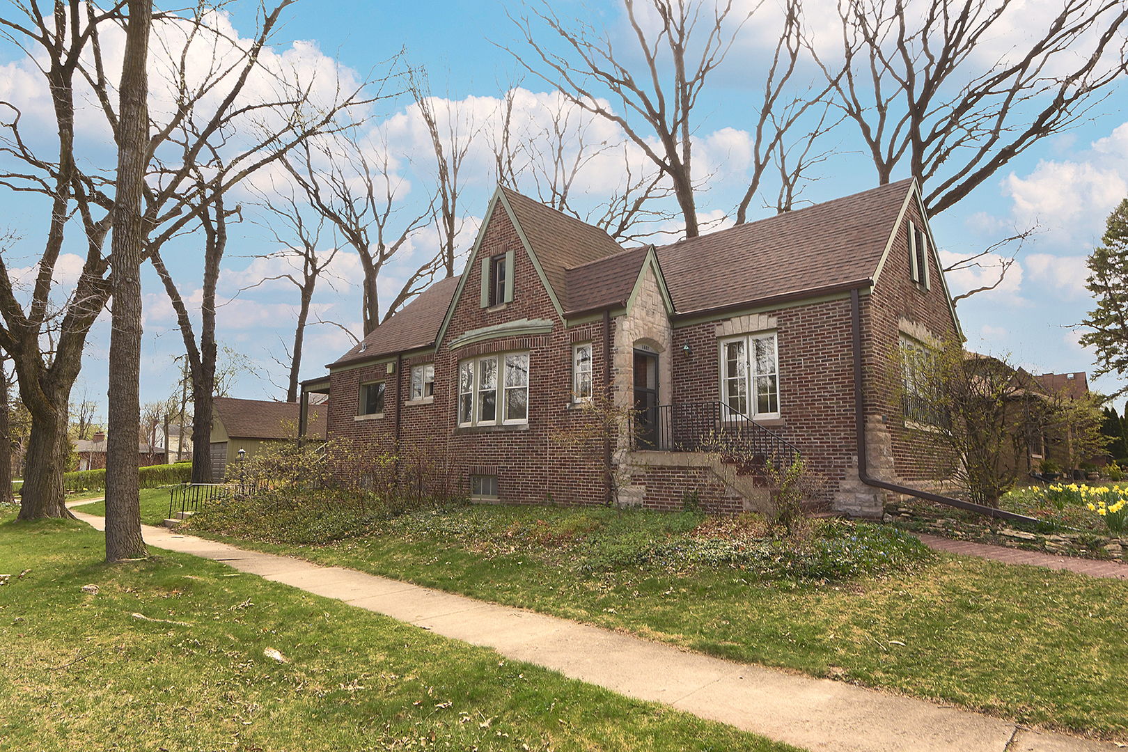 1607 Pine Road Homewood, IL 60430 - Photo 41 of 49 a view of a brick house next to a yard with large tree