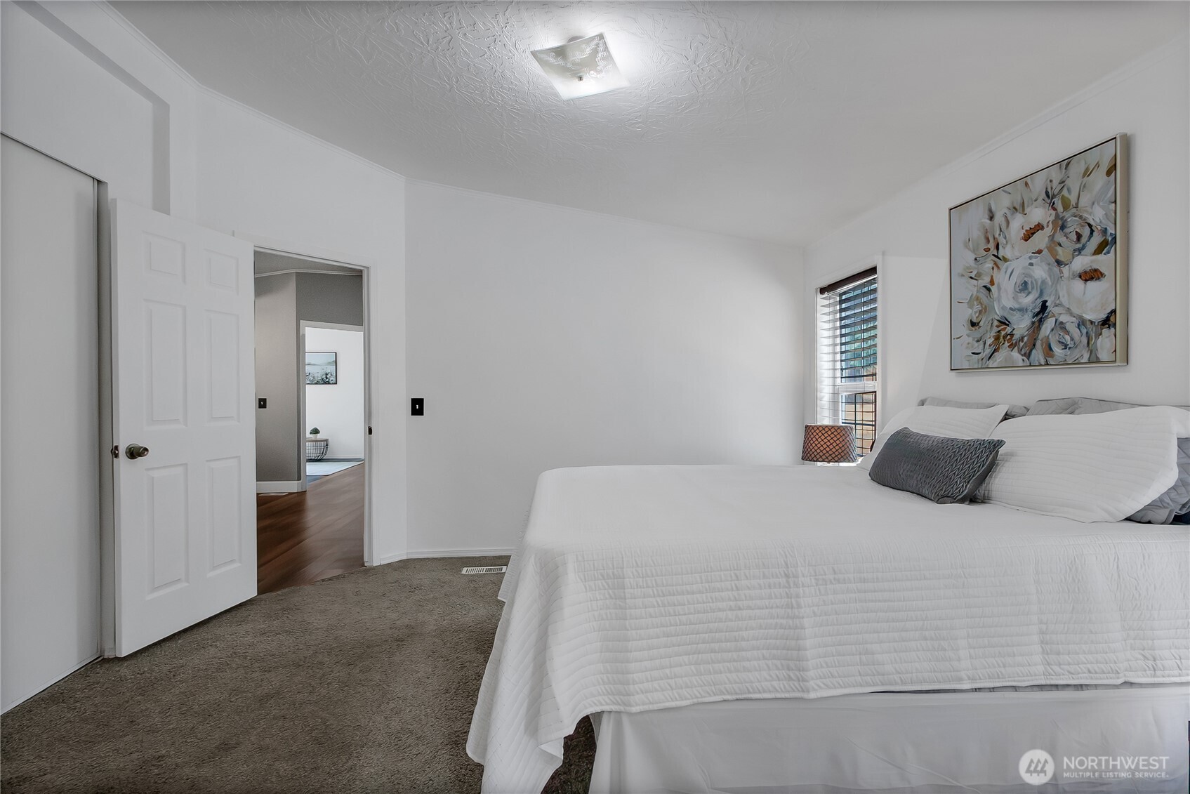 28205 73rd Avenue East Graham, WA 98338 - Photo 12 of 20 a bedroom with a large bed and a chandelier