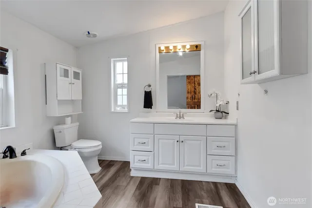 a spacious bathroom with a sink and a mirror