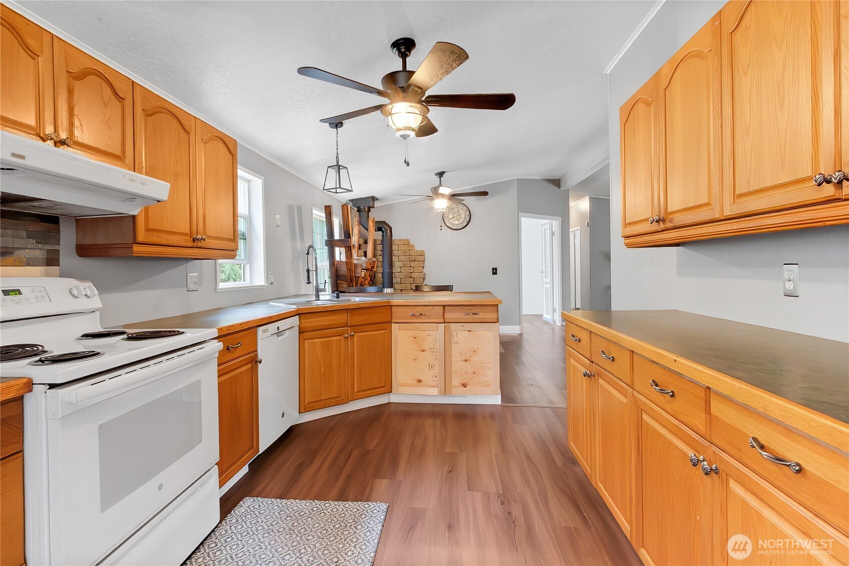 28205 73rd Avenue East Graham, WA 98338 - Photo 8 of 20 a kitchen with granite countertop a sink cabinets stainless steel appliances and a large window