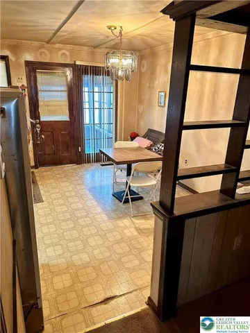 a view of an entryway with a floor to ceiling window