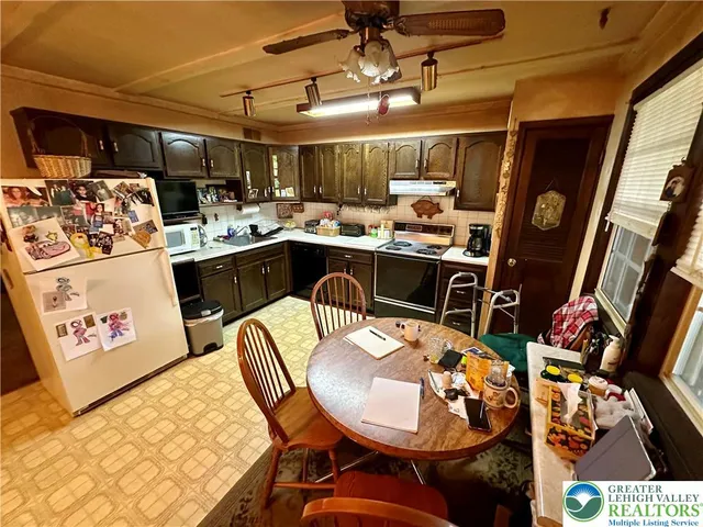a open kitchen with stainless steel appliances granite countertop a sink and cabinets