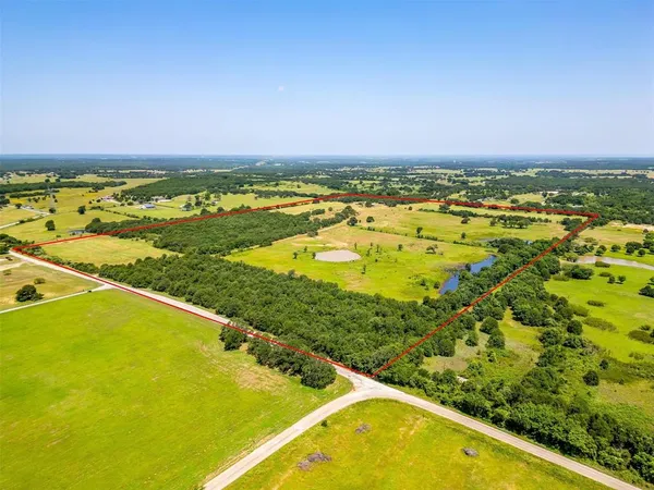 an aerial view of a residential houses with outdoor space and swimming pool