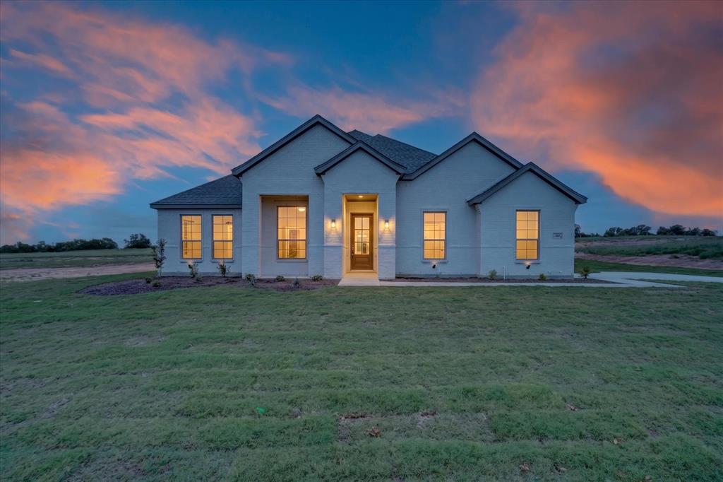 504 Clifton Court Springtown, TX 76082 - Photo 3 of 36 Single-story residence featuring a light-colored brick exterior, dark gray roof, and prominent gables