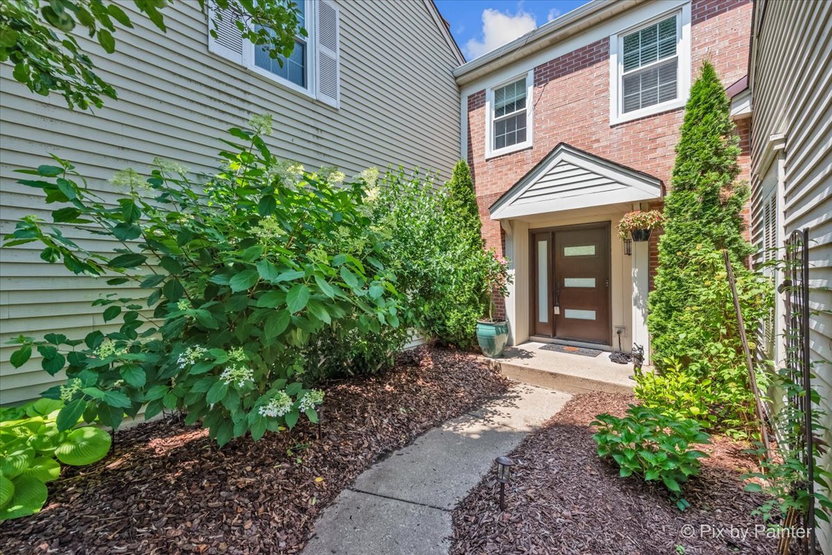 1085 Oswego Road Naperville, IL 60540 - Photo 1 of 31 a front view of a house with garden