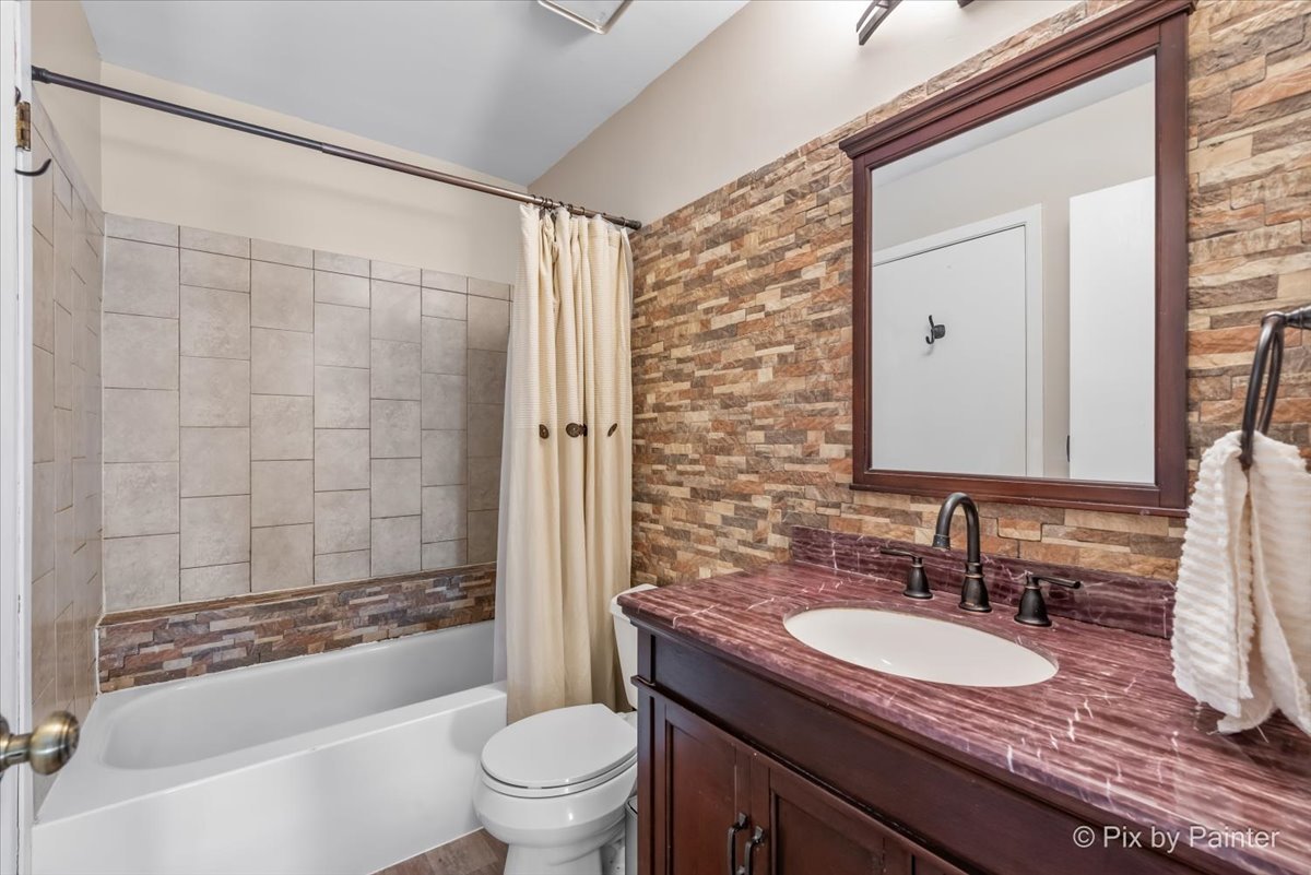 1085 Oswego Road Naperville, IL 60540 - Photo 18 of 31 a bathroom with a granite countertop sink toilet and shower