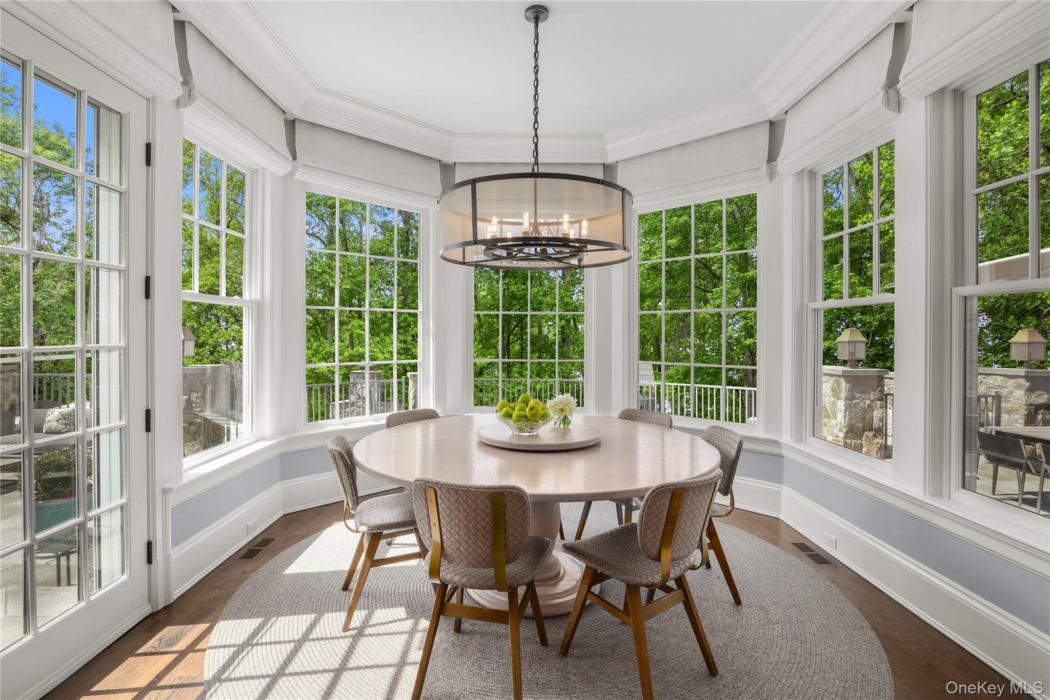 6 Stone Bridge Road Purchase, NY 10577 - Photo 12 of 45 a dining room with furniture large windows and wooden floor