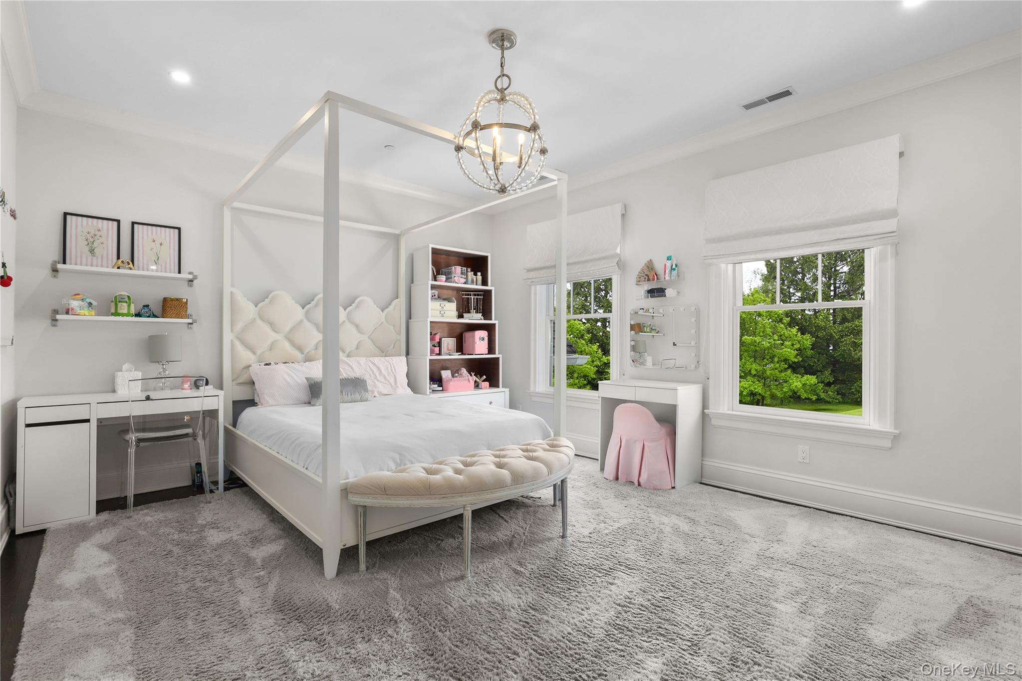 6 Stone Bridge Road Purchase, NY 10577 - Photo 24 of 45 a bedroom with a large bed and a chandelier