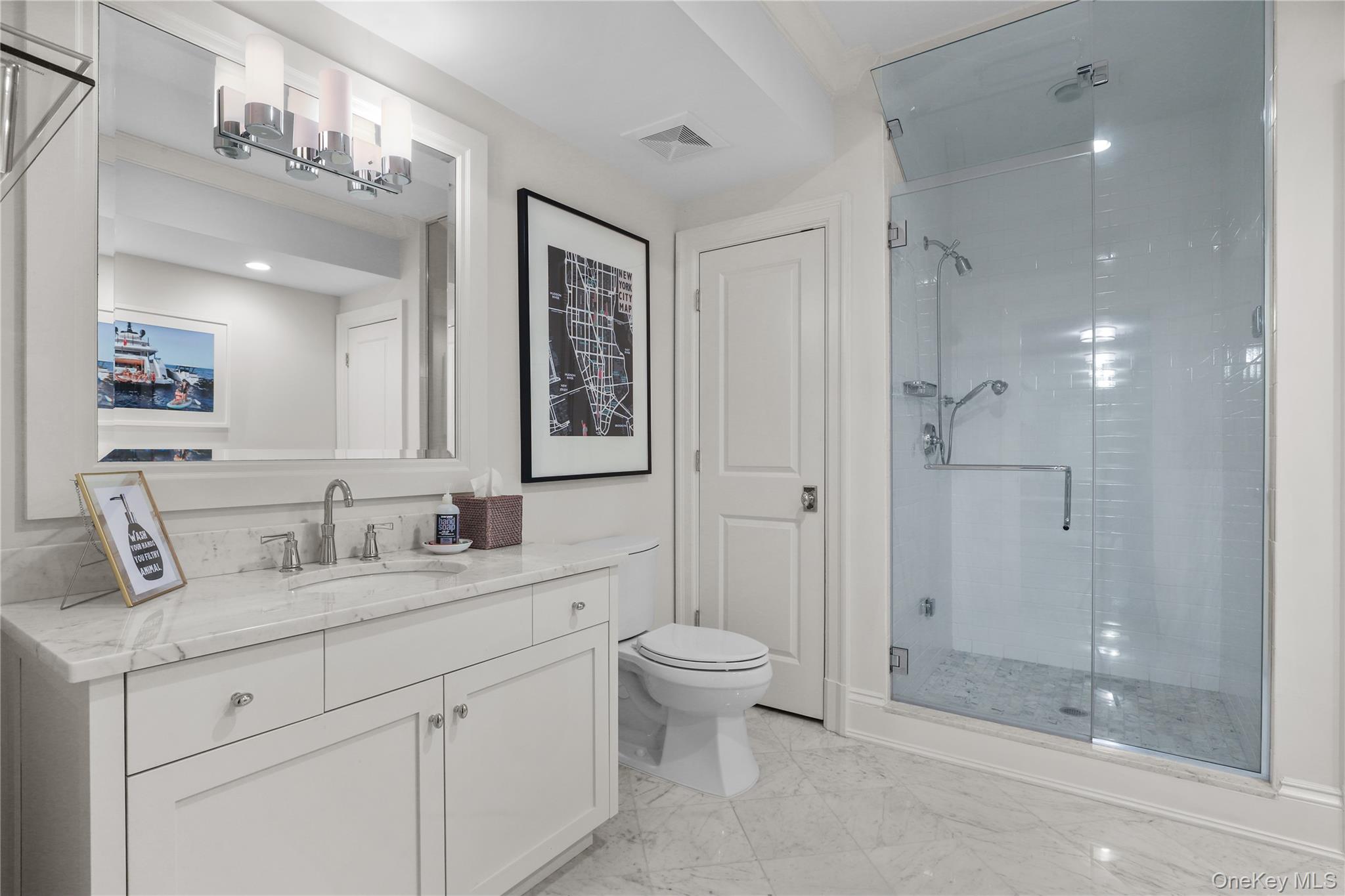 6 Stone Bridge Road Purchase, NY 10577 - Photo 32 of 45 a bathroom with a double vanity sink toilet mirror and windows