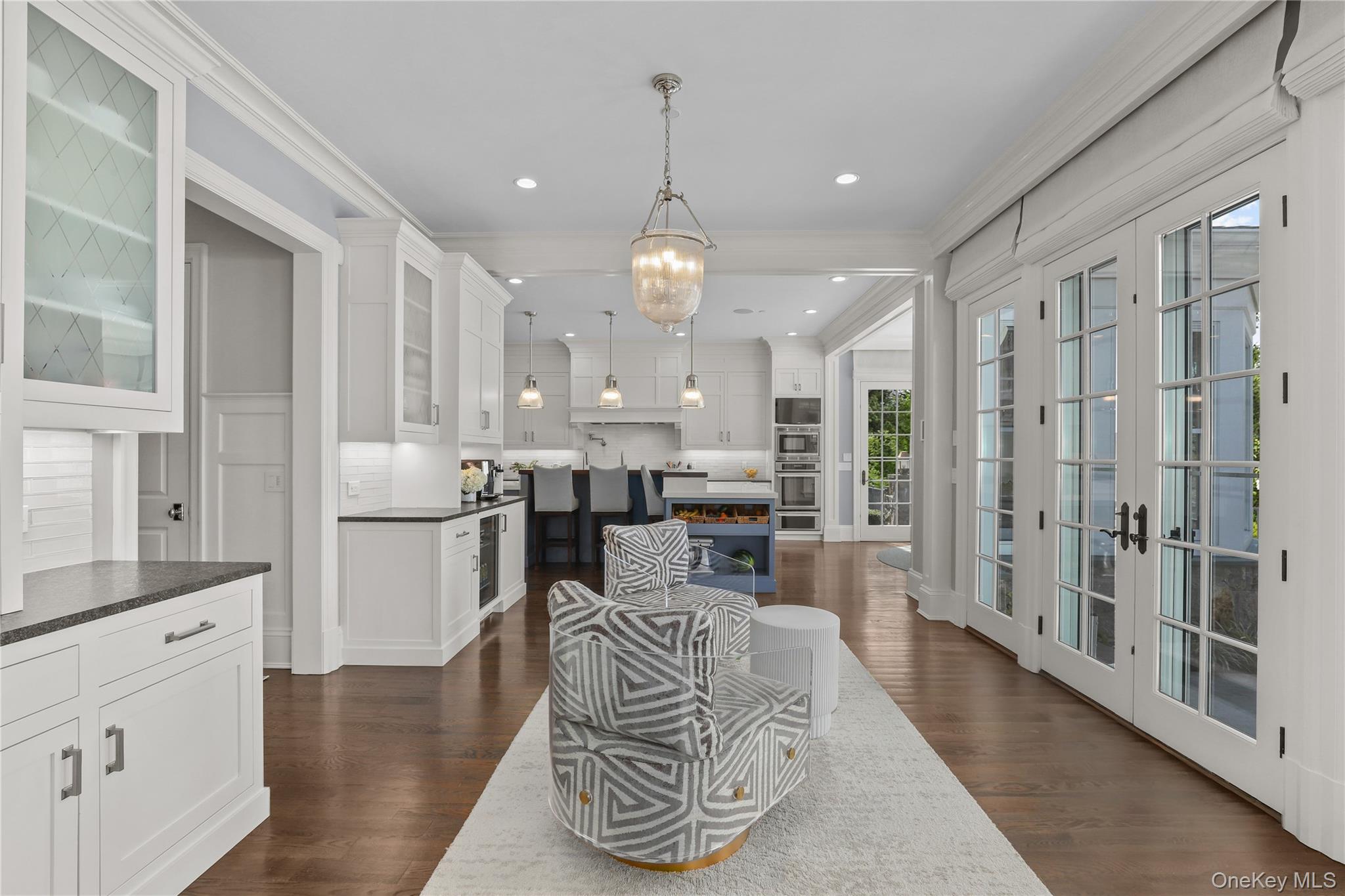 6 Stone Bridge Road Purchase, NY 10577 - Photo 9 of 45 a dining room with furniture a chandelier and wooden floor