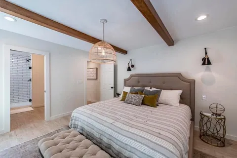 a bedroom with bed and window