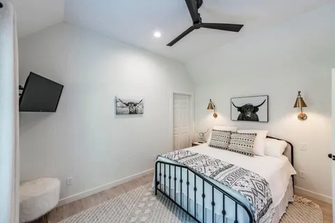 a bedroom with a bed and a flat screen tv
