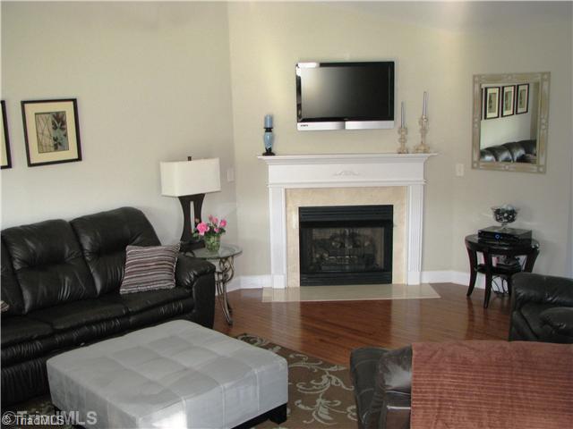 286 Crousetown Road Lexington, NC 27292 - Photo 5 of 16 Living Room. The living room provides hardwood floors, a warm fireplace and is open to the kitchen.