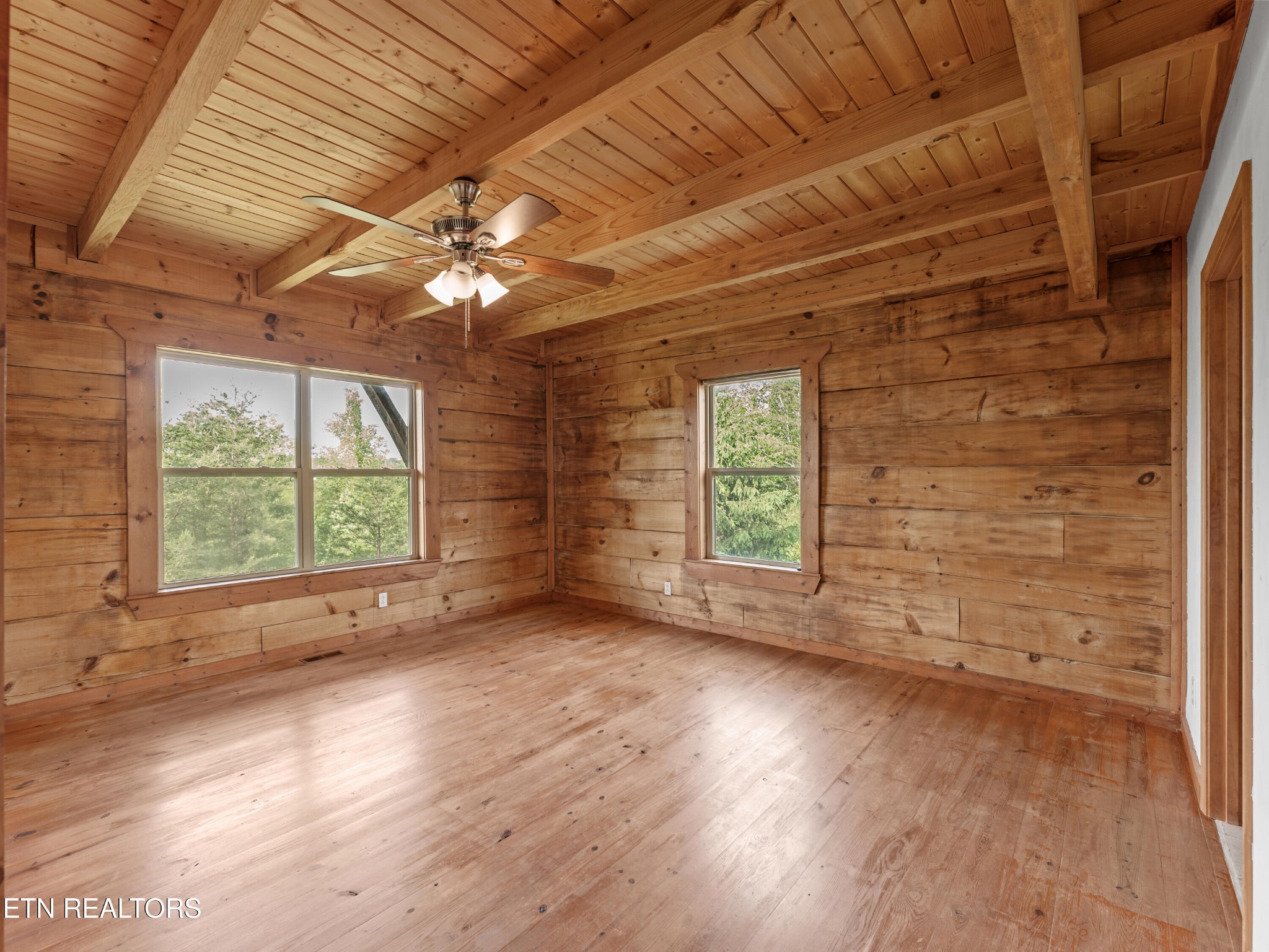 155 George Thomas Road Vonore, TN 37885 - Photo 23 of 51 an empty room with wooden floor and windows