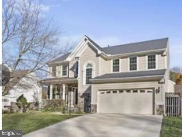 a front view of a house with a garden and plants