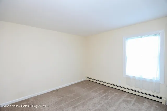 a view of an empty room and a window