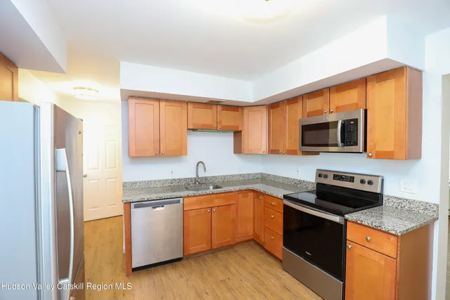 a kitchen with a sink a microwave a stove and refrigerator