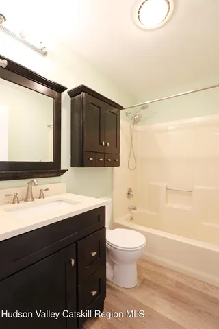 a bathroom with a sink a toilet and a bathtub