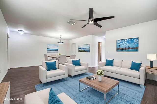 a living room with furniture and a wooden floor