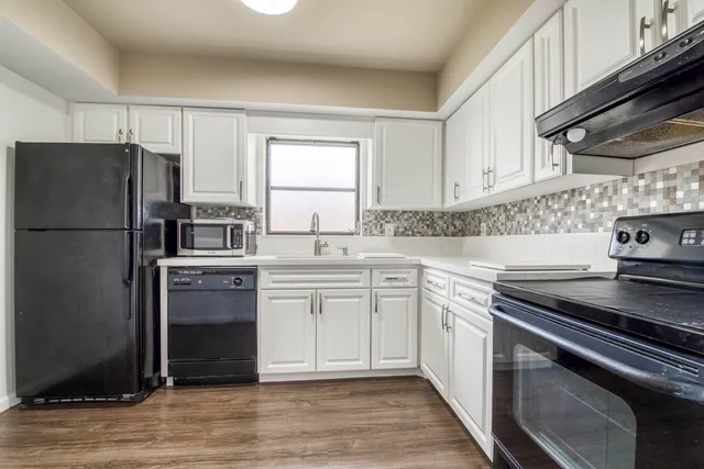 a kitchen with stainless steel appliances granite countertop a stove a refrigerator and a sink