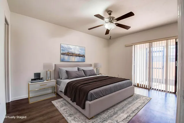 a bedroom with a large bed and a ceiling fan