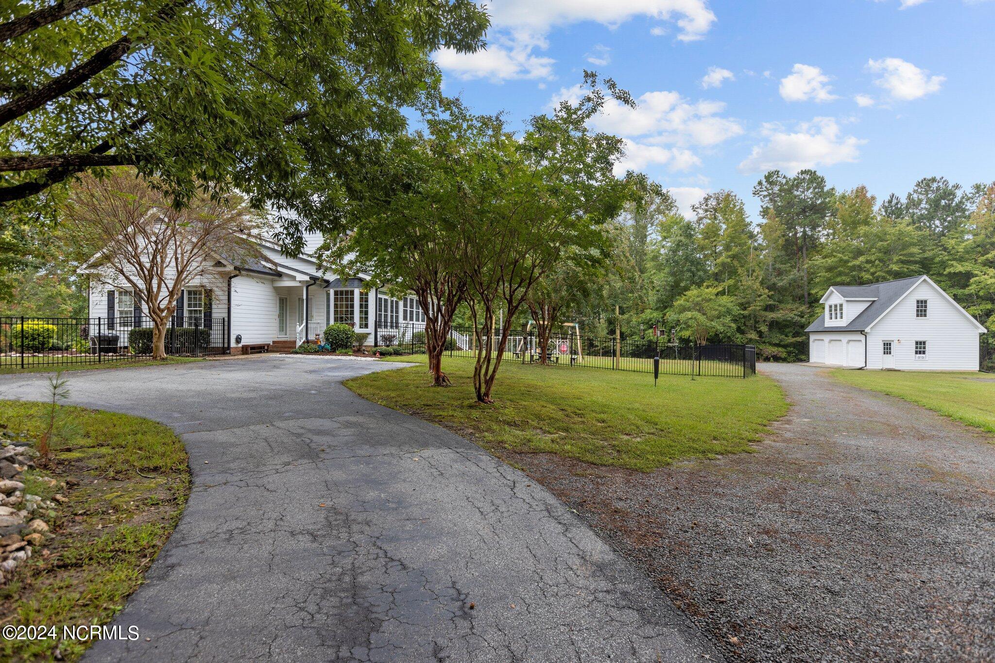 4077 Range Road Stem, NC 27581 - Photo 64 of 67 Circular driveway with paved drive back to 3-car garage.