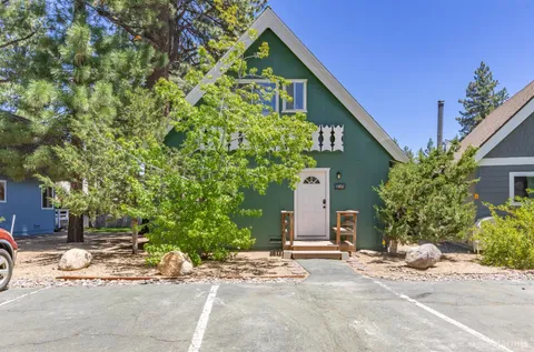 a view of a house with a yard and plant