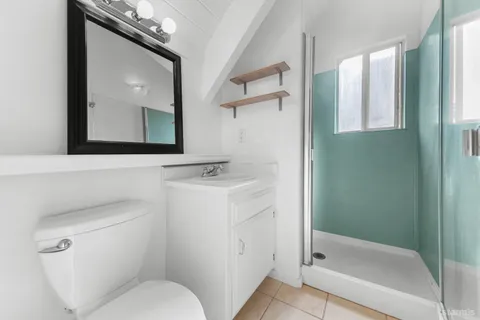 a bathroom with a toilet sink and shower