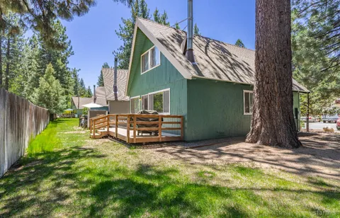 a view of a house with backyard porch and sitting area