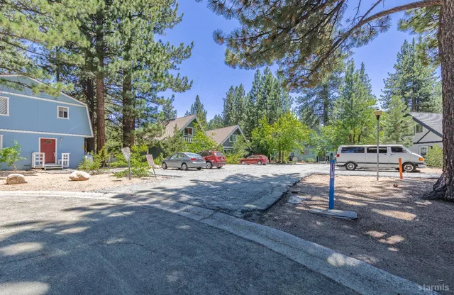 an aerial view of a house with a yard and lake view