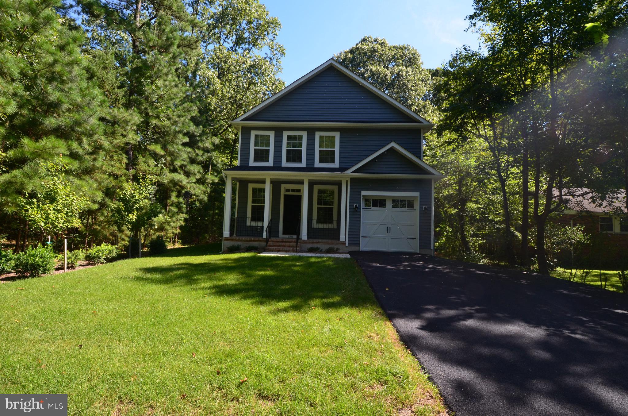 5917 Sneed Drive Deale, MD 20751 - Photo 2 of 26 a front view of a house with a garden