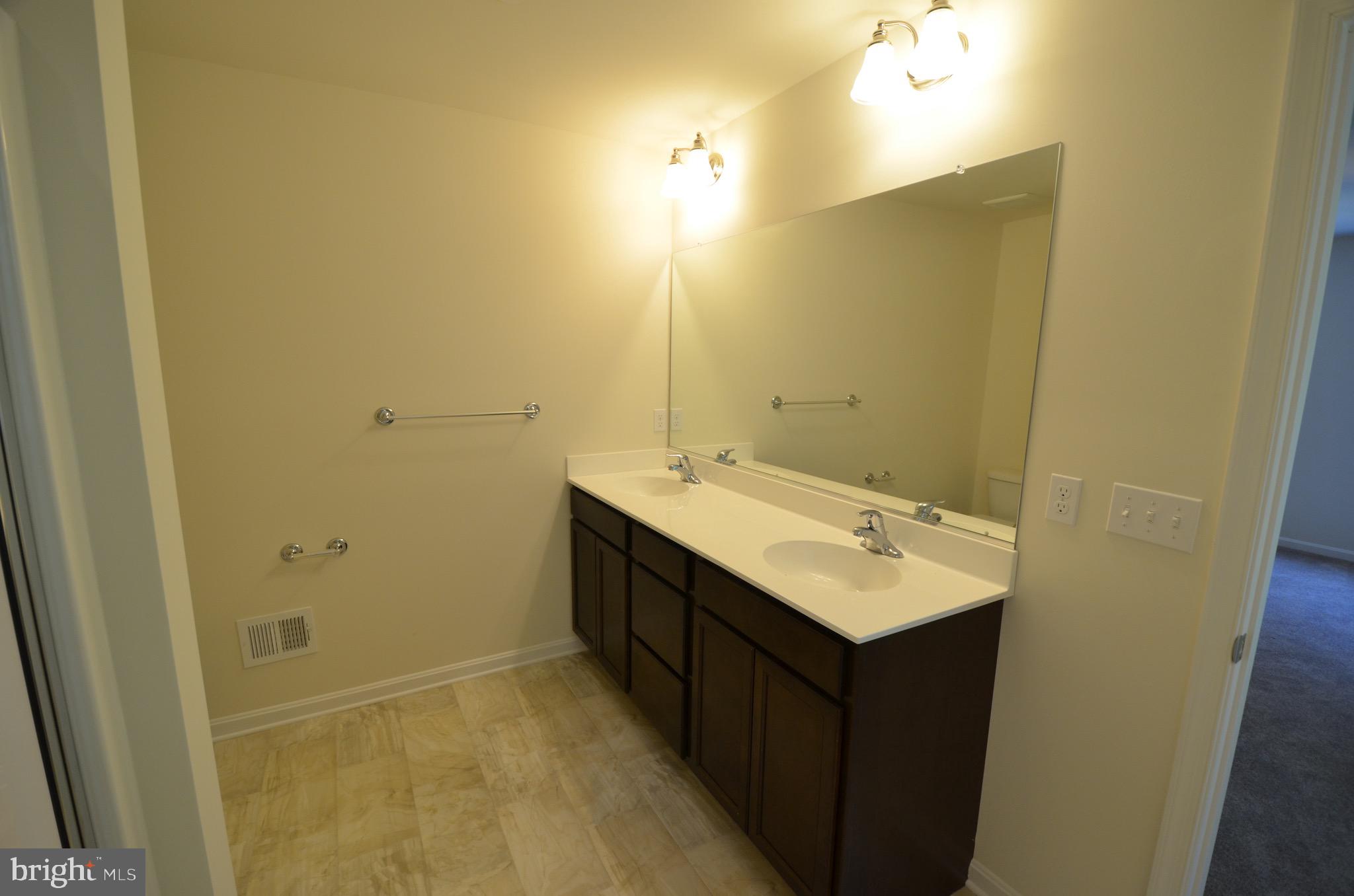 5917 Sneed Drive Deale, MD 20751 - Photo 24 of 26 a bathroom with a sink vanity and mirror