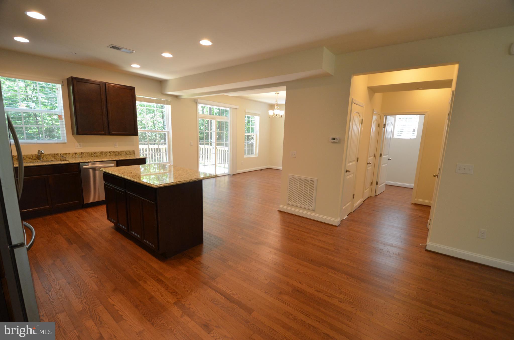 5917 Sneed Drive Deale, MD 20751 - Photo 5 of 26 a large kitchen with stainless steel appliances granite countertop a stove and a wooden floors