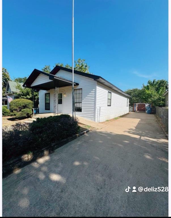 715 West Monterey Street Denison, TX 75020 - Photo 2 of 9 a front view of a house with a garden