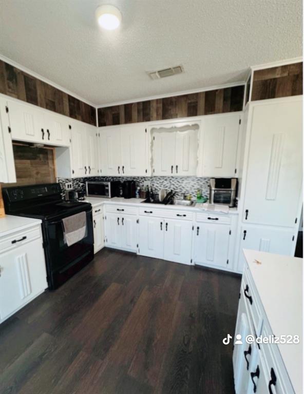 715 West Monterey Street Denison, TX 75020 - Photo 3 of 9 a kitchen with granite countertop a sink a stove a microwave and cabinets
