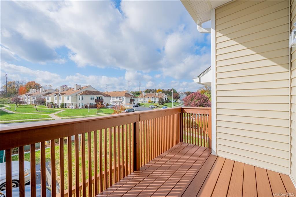 This airy balcony is just one of the desirable features this all upgrade condo offers to buyers; a second floor, premier end unit in a brand new building in Whispering Hills in bucolic Chester, New York.