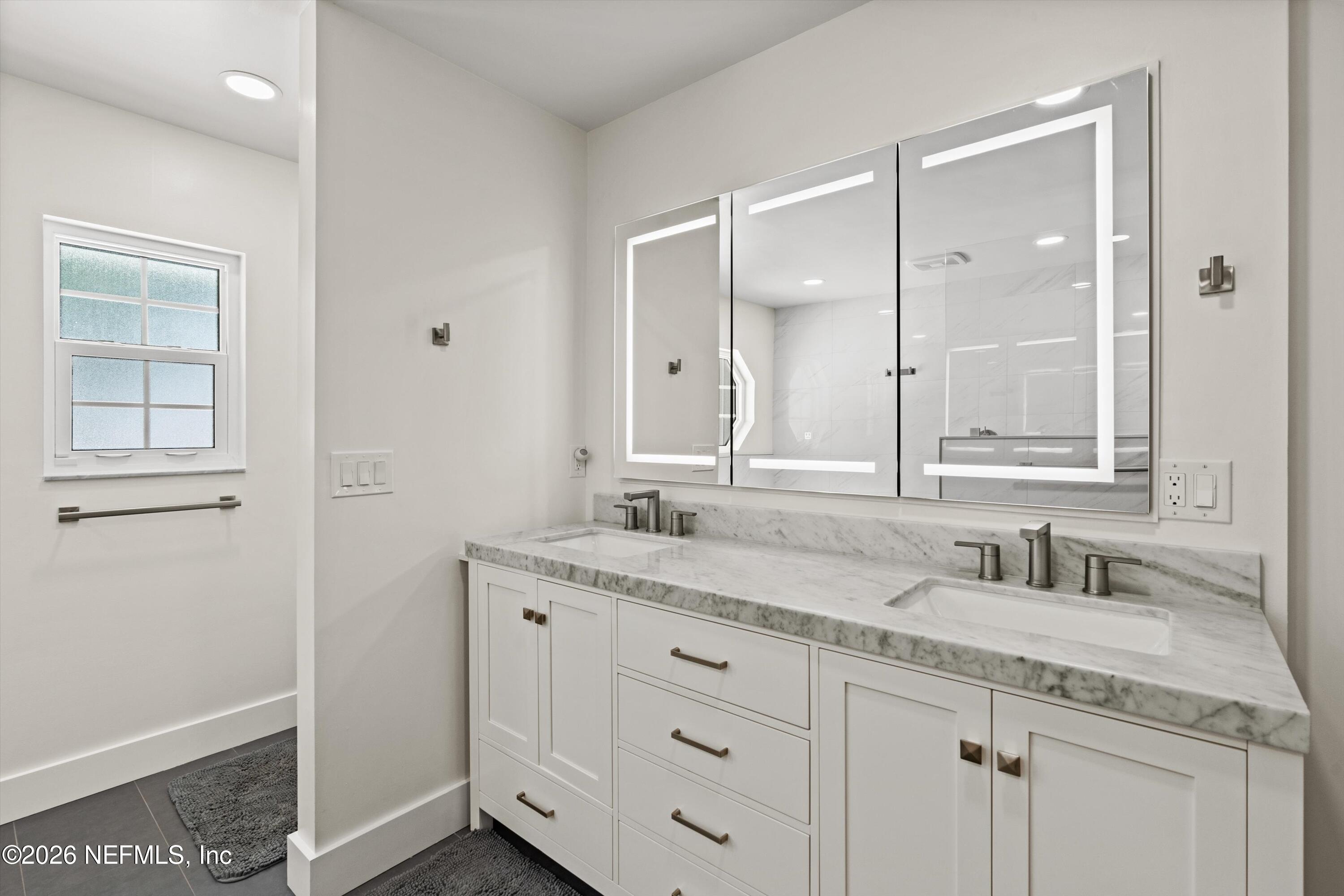 5566 Don Manuel Road Elkton, FL 32033 - Photo 20 of 47 a bathroom with a granite countertop sink mirror and double