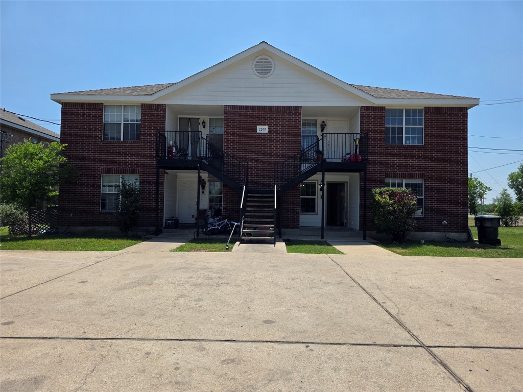 a front view of a house with a yard and a garage