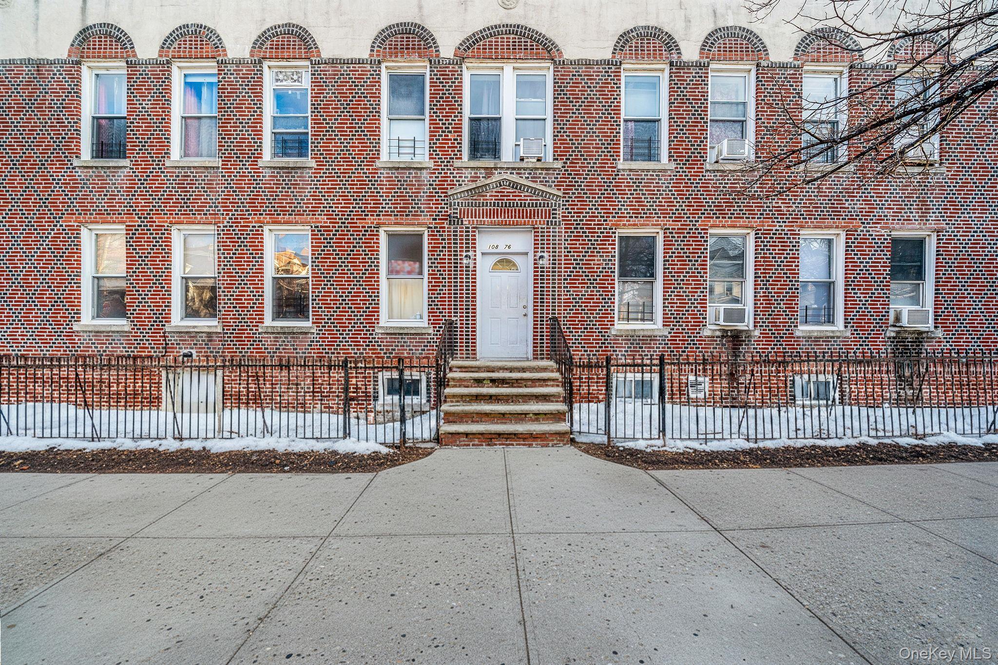 a view of a brick building with many windows
