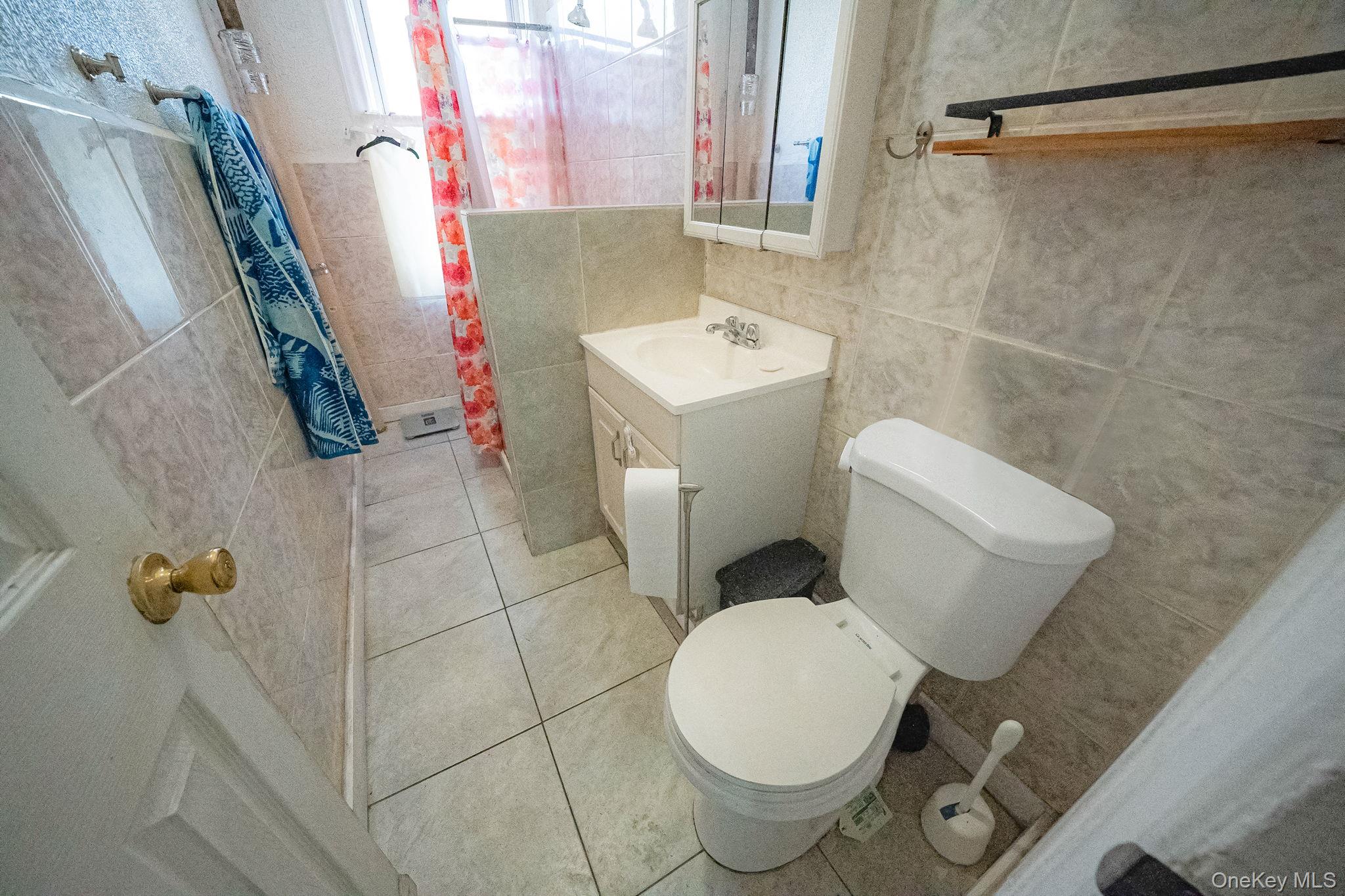 108-76 38th Avenue Queens, NY 11368 - Photo 12 of 38 a white toilet sitting next to a bathroom sink