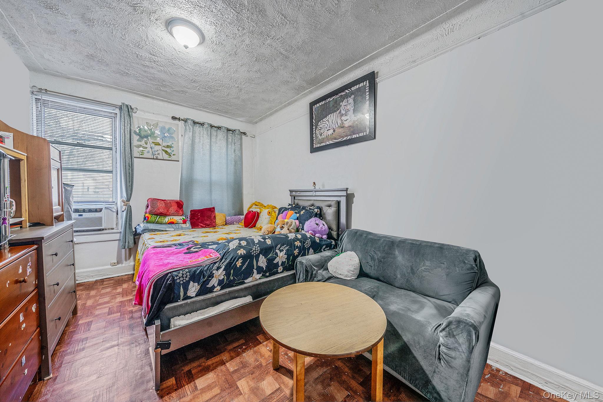 108-76 38th Avenue Queens, NY 11368 - Photo 16 of 38 a living room with furniture and a flat screen tv