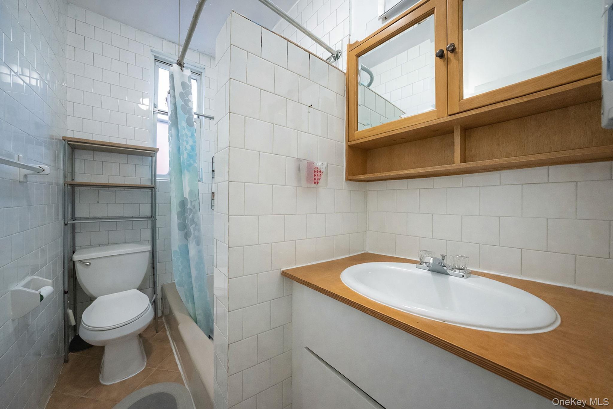 108-76 38th Avenue Queens, NY 11368 - Photo 17 of 38 a bathroom with a sink a toilet and shower