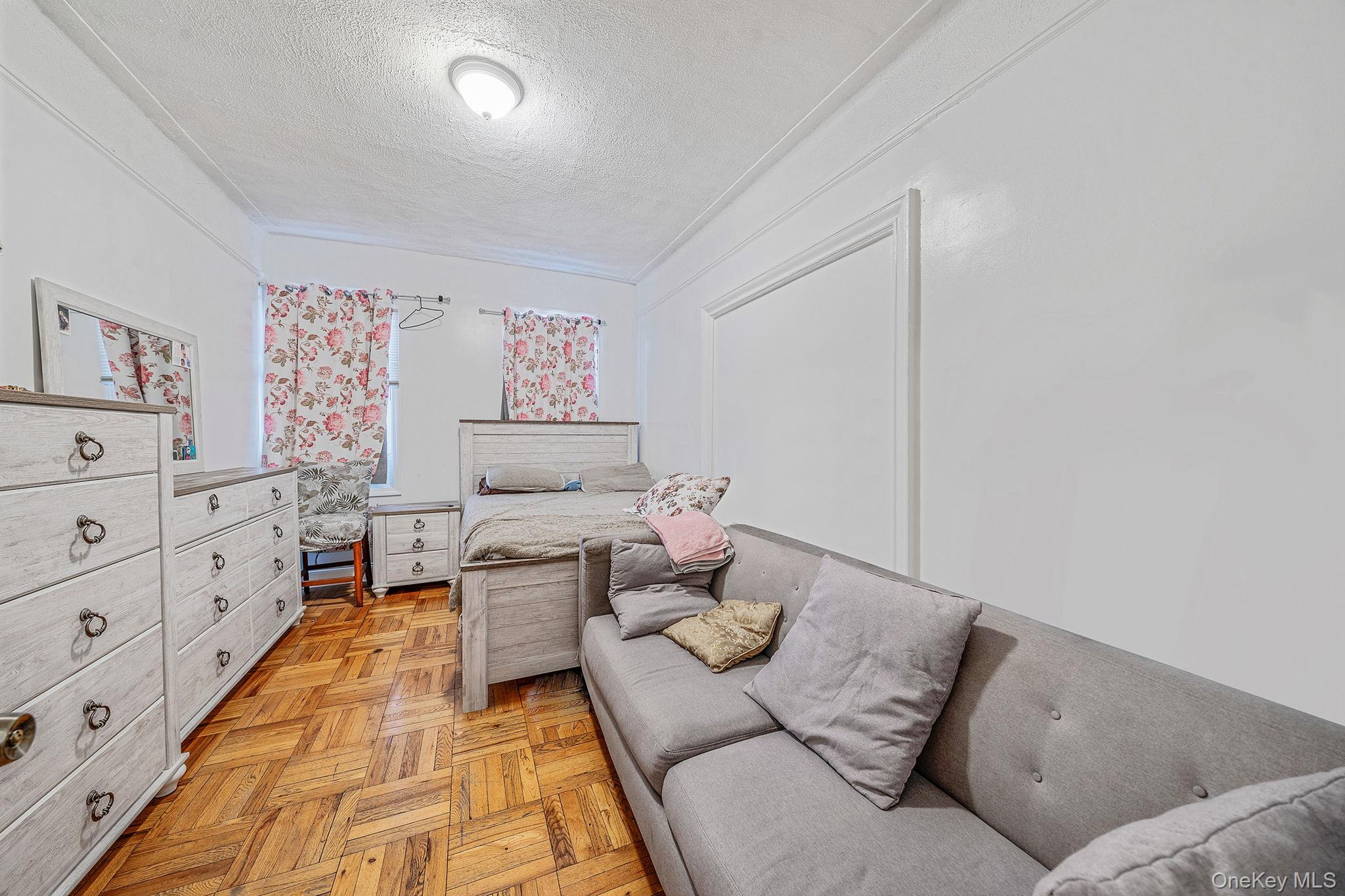108-76 38th Avenue Queens, NY 11368 - Photo 18 of 38 a living room with furniture and painting on the wall