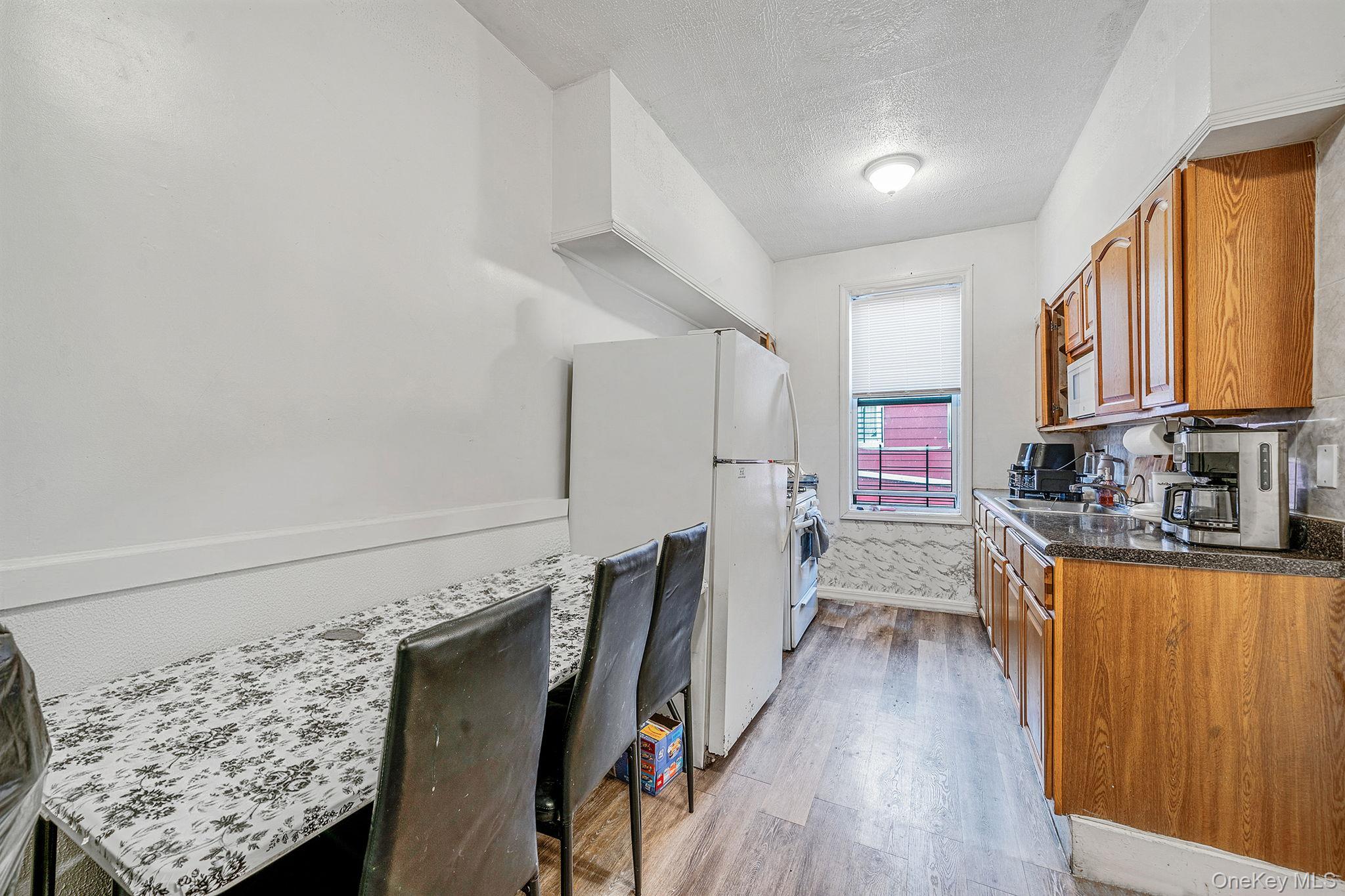 108-76 38th Avenue Queens, NY 11368 - Photo 21 of 38 a view of a kitchen with wooden floor