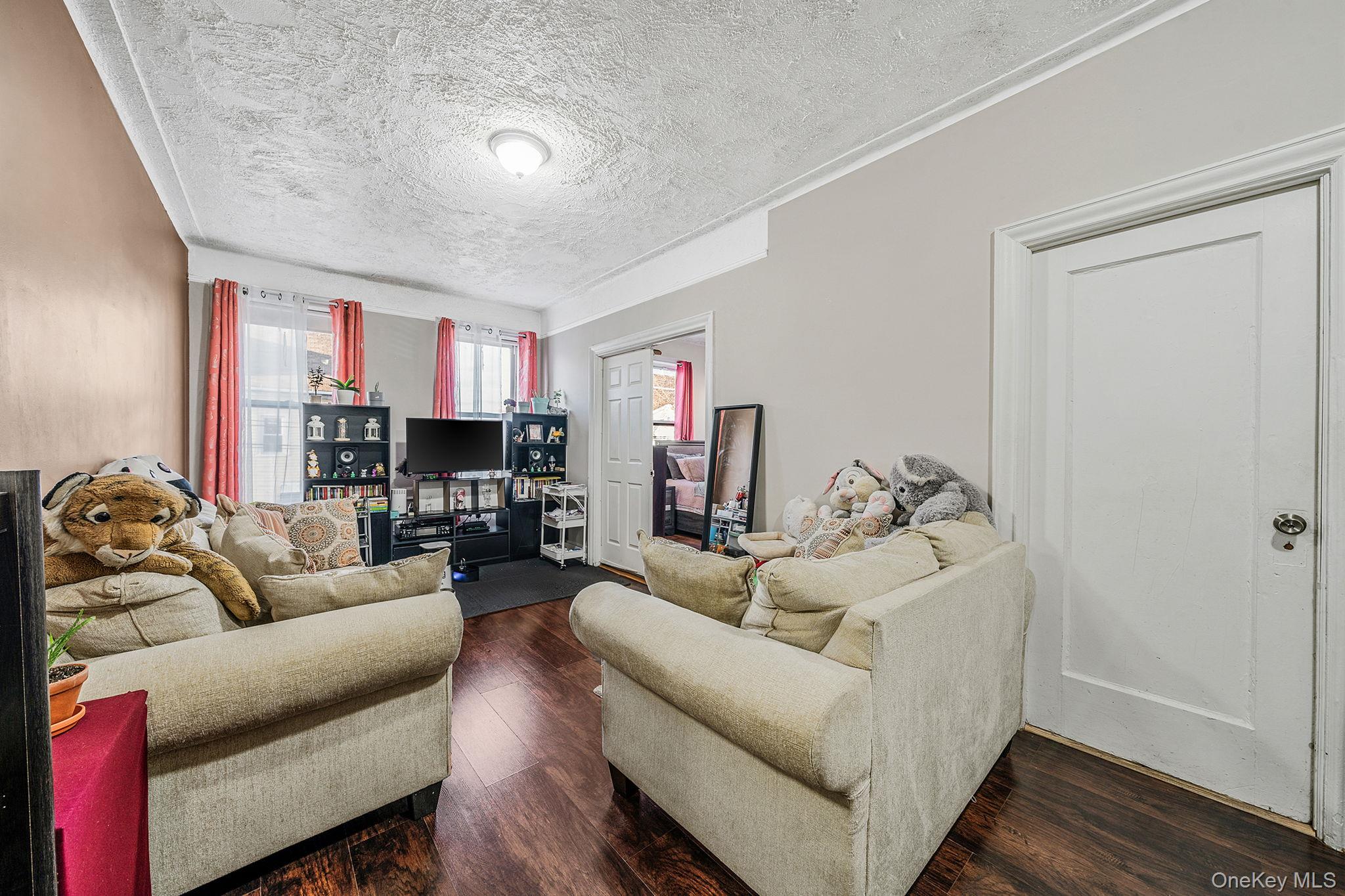 108-76 38th Avenue Queens, NY 11368 - Photo 24 of 38 a living room with furniture and a fireplace