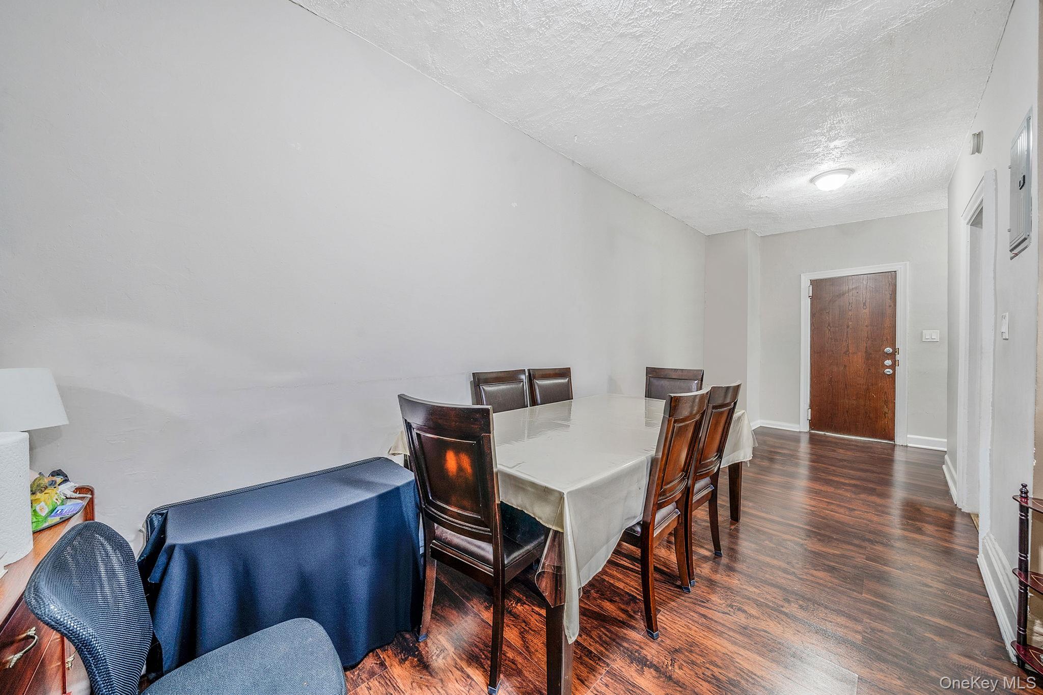 108-76 38th Avenue Queens, NY 11368 - Photo 26 of 38 a view of a dining room with furniture and wooden floor