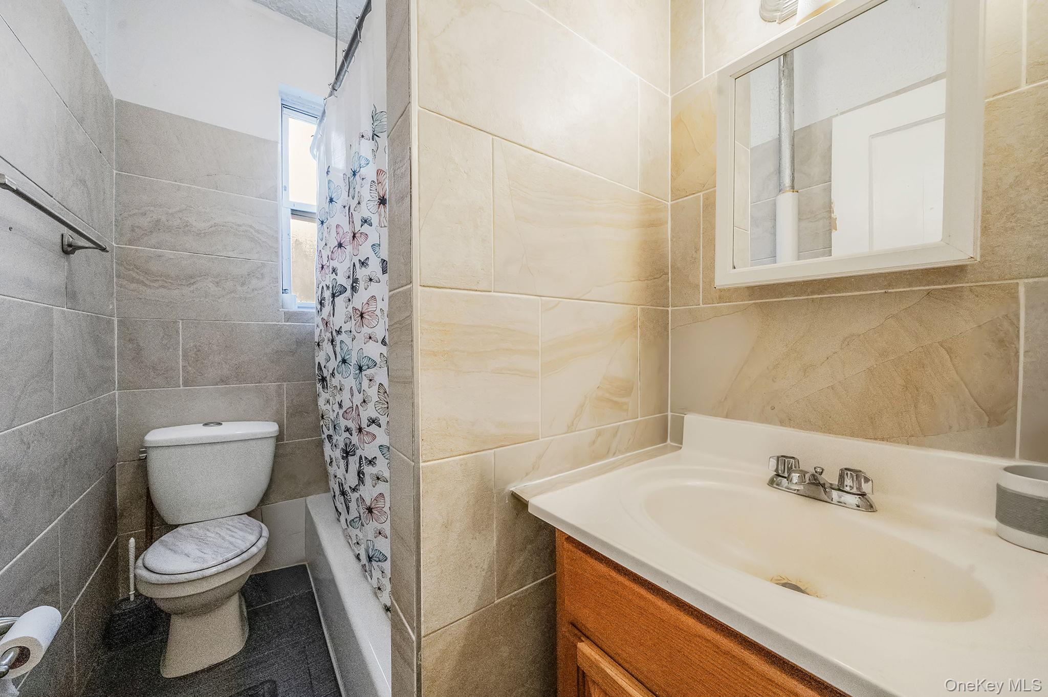 108-76 38th Avenue Queens, NY 11368 - Photo 32 of 38 a bathroom with a sink toilet and shower