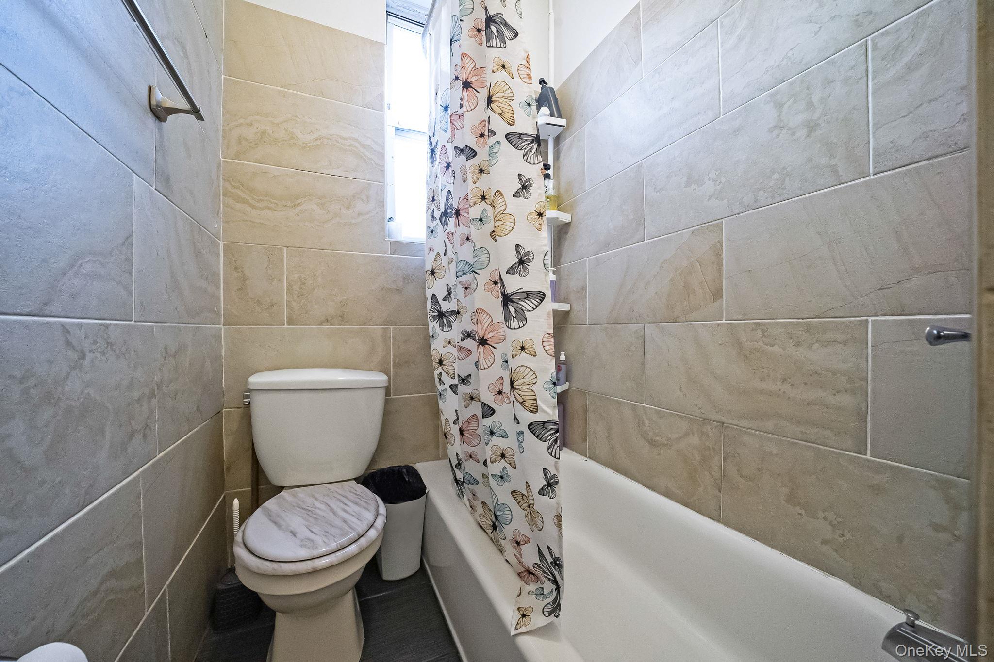 108-76 38th Avenue Queens, NY 11368 - Photo 33 of 38 a bathroom with a toilet and a shower