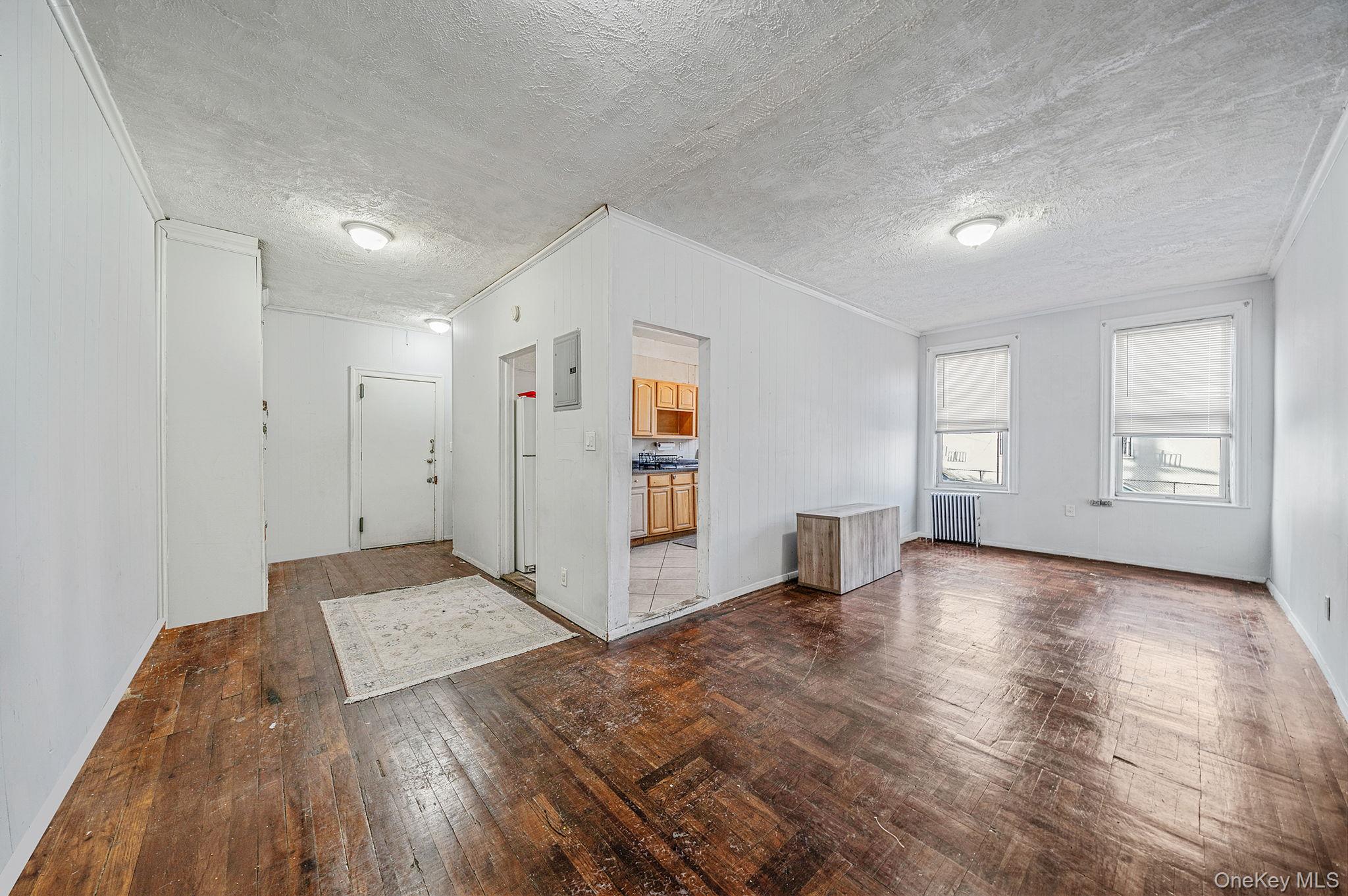 108-76 38th Avenue Queens, NY 11368 - Photo 4 of 38 a view of a room with wooden floor and window